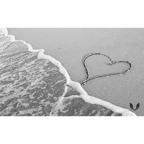 A heart drawn on the beach sand
